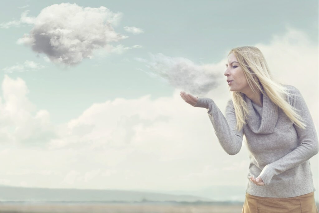 Woman,with,magical,powers,creating,clouds,blowing